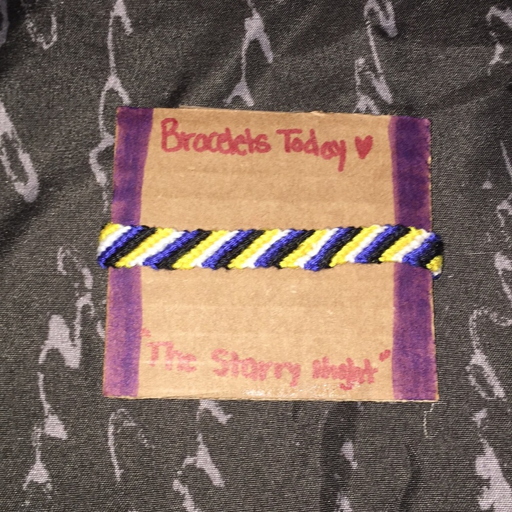 A striped styled bracelet made of cotton string.